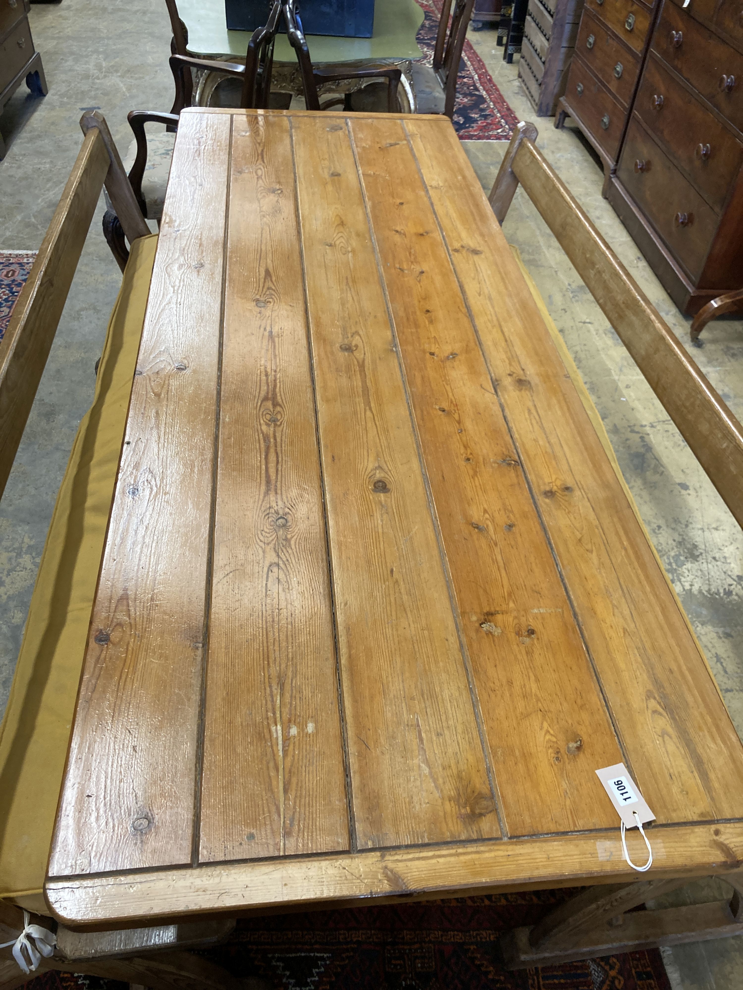 A rectangular pine kitchen table, width 218cm, depth 77cm, height 77cm together with a pair of Victorian pitch pine bench seats